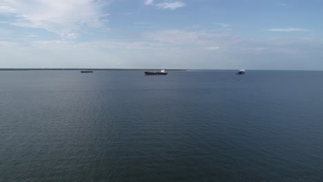 This-is-an-aerial-video-over-cargo-ships-entering-a-port-in-Galveston,-Texas