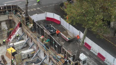 Empty-Skip-Being-Lifted-by-Crane-At-Construction-Site-In-Westminster
