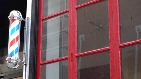 A-barbershop-pole-near-a-red-window