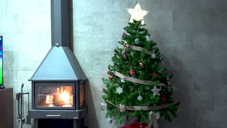 Christmas-tree-decorated-by-iron-fireplace-with-fire-plugged-in