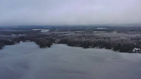 Flying-over-frozen-lake-in-ice-cold-winter