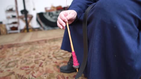 A-lady-hand-spinning-yarn-in-a-traditional-manner