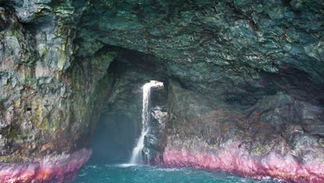 HD-Hawaii-Kauai-Boating-on-the-ocean-medium-shot-truck-in-toward-waterfall-in-ocean-cave
