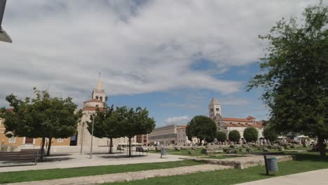 Square-with-ancient-Roman-ruins,-and-Church-of-St