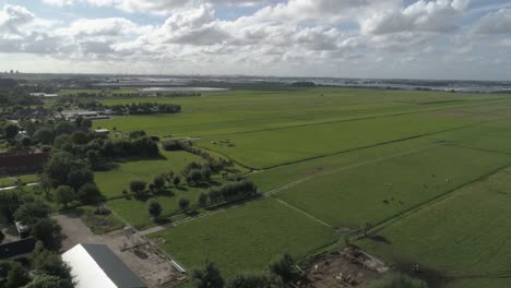 Aerial-Slowmotion-of-Beautiful-Dutch-Countryside-during-Sunset-with-Cities-in-the-background