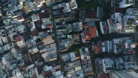 Slow-descending-top-down-areial-view-from-a-high-angle-of-Binh-Thanh-district,-a-residential-area-of-Ho-Chi-Minh-City,-Vietnam-looking-at-rooftops-and-narrow-streets