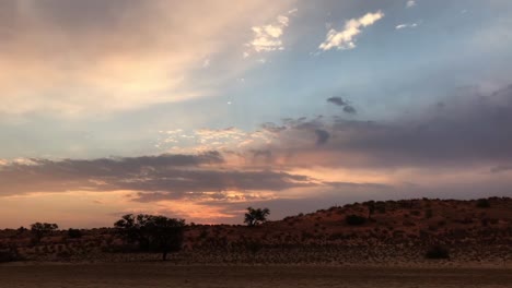 Multicolor-morning-sky-on-a-slow-drive-through-the-Kalahari-Desert