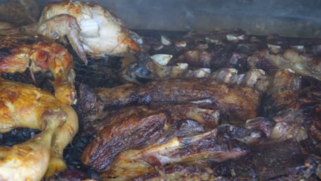 Close-up-shot-of-roasted-Argentinian-barbecue-or-asado-over-smoky-parrilla