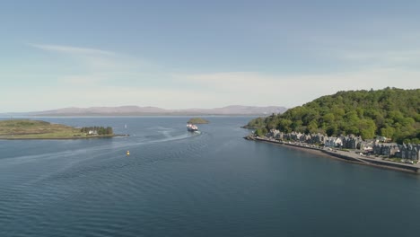 Aerial-shot-revealing-the-sea-entrance-to-Oban-with-Ferry-departing-towards-Mull