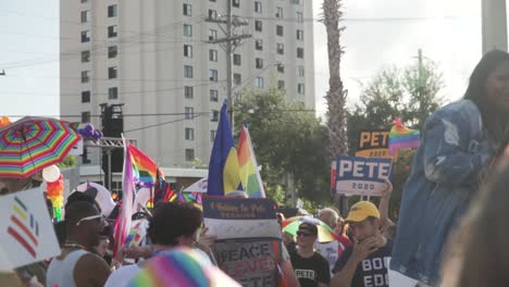 Slow-Motion-Shot-of-People-Marching-in-Street-at-River-City-Pride-Parade-With-Equality-and-LGBTQ-Flags-in-Jacksonville,-FL