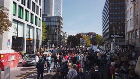 A-group-of-protesters-on-a-demonstration-agains-climate-change-and-for-political-action-to-halt-global-warming-is-moving-through-the-streets-of-Cologne