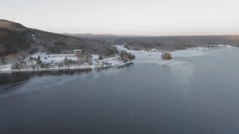 Flying-towards-a-tourist-community-on-the-shore-of-Moosehead-Lake-at-dawn-AERIAL