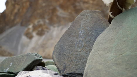 Carved-stones-on-the-mountains-with-ancient-drawings,-scripts