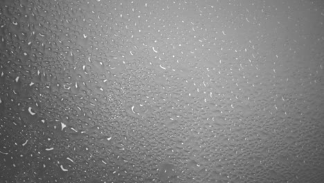 Background-of-steaming-hot-water-forms-many-water-droplets-on-a-glass-surface
