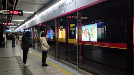 Coronavirus-outbreak,-few-people-wearing-masks-and-waiting-for-the-train-in-empty-metro-of-Guangzhou-city