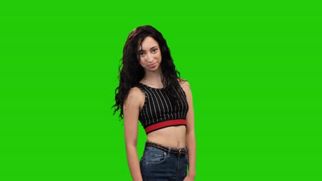 Slim-girl-with-long-curly-hair-turns-on-green-screen