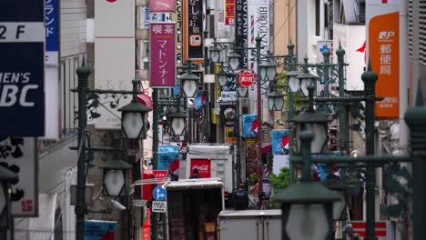 Zeitlupe-Einer-Engen-Straße-Von-Tokio-Voller-Werbeschilder-Und-Straßenlaternen