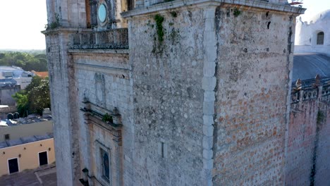 Extreme-closeup-aerial-ascent-on-corner-of-the-backlit-Cathedral-de-San-Gervasio-in-Valladolid,-Yucatan,-Mexico