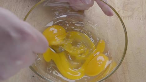 Slow-Motion-Shot-of-Starting-to-Whisk-Eggs-With-a-Fork-in-the-Kitchen