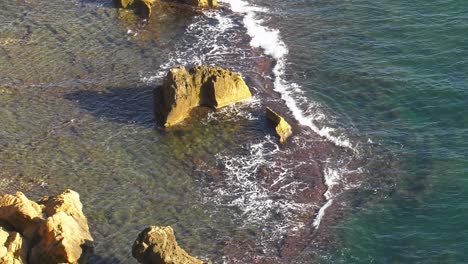 Sea-Waves-breaking-over-reef-on-rocky-coast,-coastal-seascape