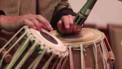 Medium-close-up-of-a-mans-hands-tapping-out-a-rhythm-on-a-pair-of-tabla-drums