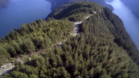 A-revealing-aerial-view-of-tree-covered-mountain-tops-surrounded-by-lakes-in-Mission-BC