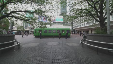 The-Famous-Green-Bus-Next-To-Shibuya-Station-In-Tokyo,-Japan-Under-World-Lockdown-With-No-Tourists-And-Few-People-Roaming-Around-During-COVID-19-Pandemic---Wide-Shot