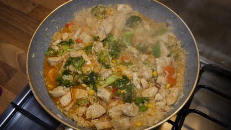 Cooking-chicken-stew-in-hot-pan-with-steam-comming-out