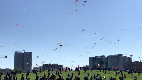 Wide-shot-looking-Southwest-at-Cricket-Hill-at-Montrose-Harbor-in-Chicago-with-people-flying-kites-during-the-kids-and-kites-festival