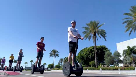 4K-Video-of-Tourists-on-Segways-Riding-Past-The-Dali-Museum-in-St-Petersburg,-Florida