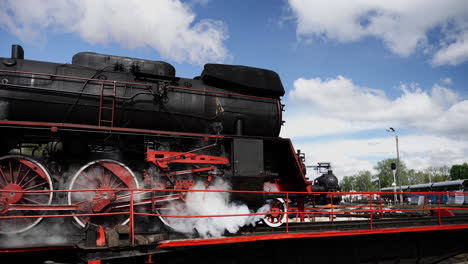 Close-shot-historic-locomotive-steam-train-slowly-reach-platform,-steam-smoke