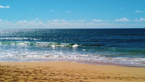 HD-Hawaii-Kauai-slow-motion-beautiful-backlit-shot-of-ocean-waves-breaking-on-the-beach-in-lower-third,-ocean-in-middle-third,-clouds-at-horizon-and-blue-sky-in-upper-third-version-three
