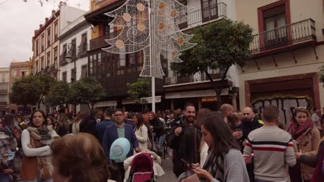 Seville-square-filled-with-people-during-Christmas-holidays-in-Spain,-Slowmo