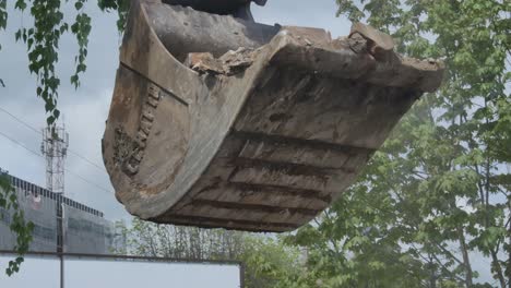 Excavator-With-Bucket-Loads-Brick-Scrap-To-The-Truck