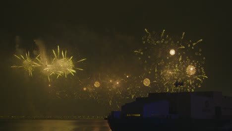 Largescale-fireworks-glowing-on-top-of-the-sea-water-with-the-silhouette-of-msheireb-museum-on-the-waterfront