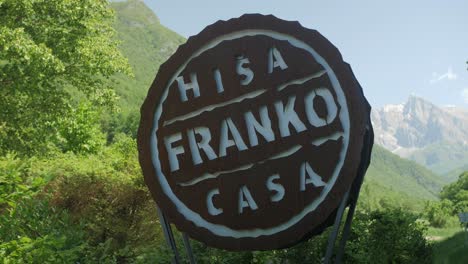 Wooden-sign-in-front-of-famous-Hisa-Franko-restaurant,-sunny-summer-day