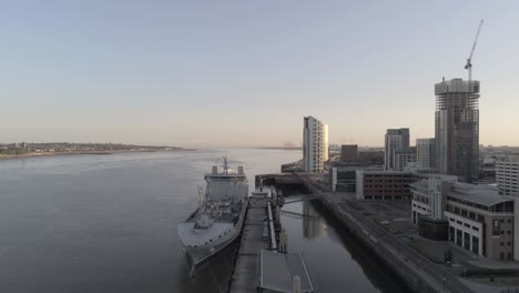 RFA-Navy-Tiderace-military-tanker-on-Liverpool-cityscape-waterfront-at-sunrise-aerial-wide-orbit-low-right-view