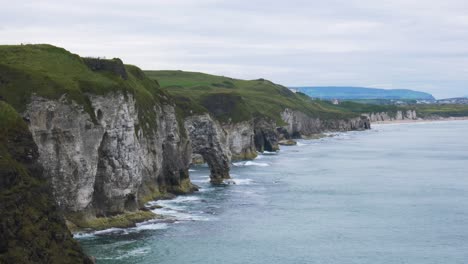 Rocky-Cliffs-Of-Whiterocks-With-Splashing-Waves-Near-The-Portrush-Town-On-County-Antrim,-Northern-Ireland-At-Daytime