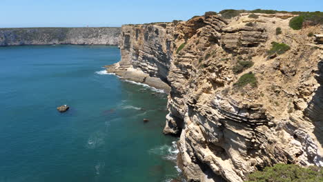 Scenic-Portuguese-Coastline-on-Atlantic-Ocean,-Ridged-Cliffs-in-Sagres,-Algarve-Region,-Tilt-Down
