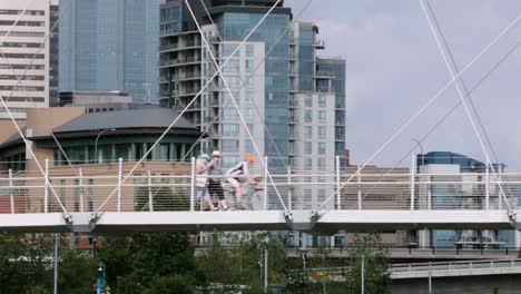 Compressed-view:-Pedestrians,-cyclists-and-scooter-on-urban-footbridge