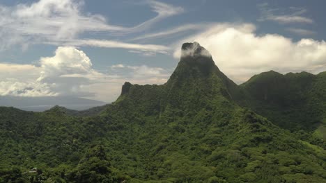 Aerial-shot-of-a-spectacular-mountain-covered-by-lush-vegetation-in-Mo'orea-island