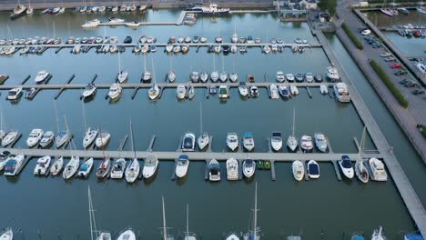 Close-up-aerial-view-of-boats-tied-up-in-dock-along-Helsinki,-Finland-waterfront