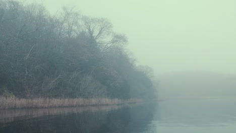 Eerie-fog-covered-islands-on-lake-in-Winter