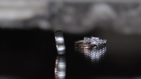 Elegant-wedding-rings-on-reflective-surface
