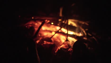 Man's-legs-against-the-bonfire-embers-in-the-forest