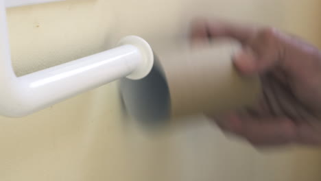 Person-Uses-Last-Sheets-Of-Toilet-Paper-and-Removes-Roll,-CLOSE-UP