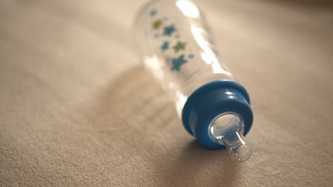 Close-Up-Tilt-of-an-Empty-Baby-Bottle