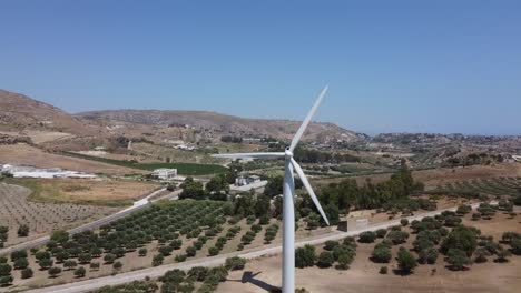 Aerial-view:-wind-turbine-turning-in-wind-on-mediterranean-hillside