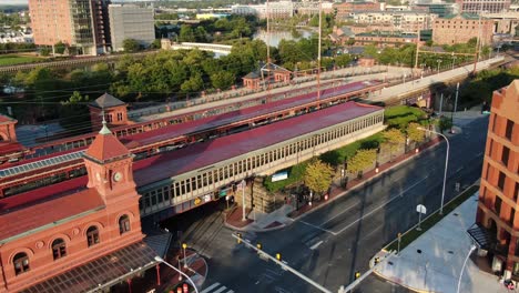 Aerial-pullback-reveals-Wilmington-Delaware-Amtrak-station,-Philadelphia-SEPTA-rail,-made-famous-by-VP-President-Joe-Biden