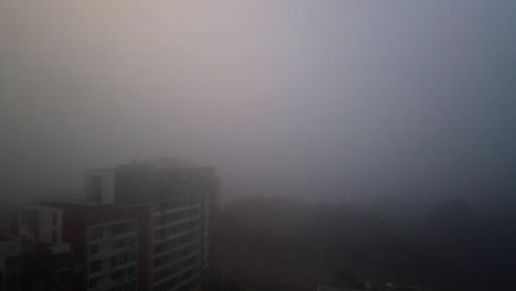 A-thick-layer-of-stormy-fog-blankets-over-parts-of-Sydney,-time-lapse-of-Sydney-covered-by-thick-and-heavy-fog-at-Princess-Highway-from-the-Balcony